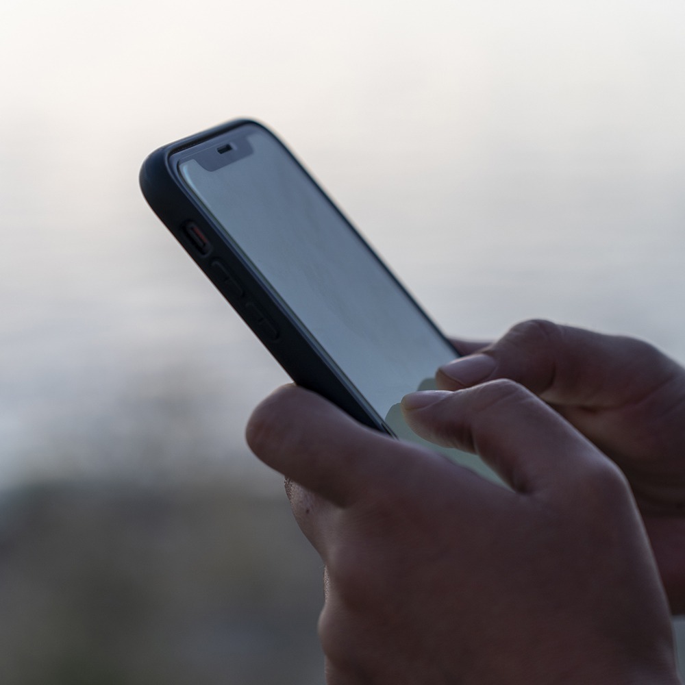 Cell phone with white screen. Screen phone suitable for mock-up. Woman holding a cell phone.